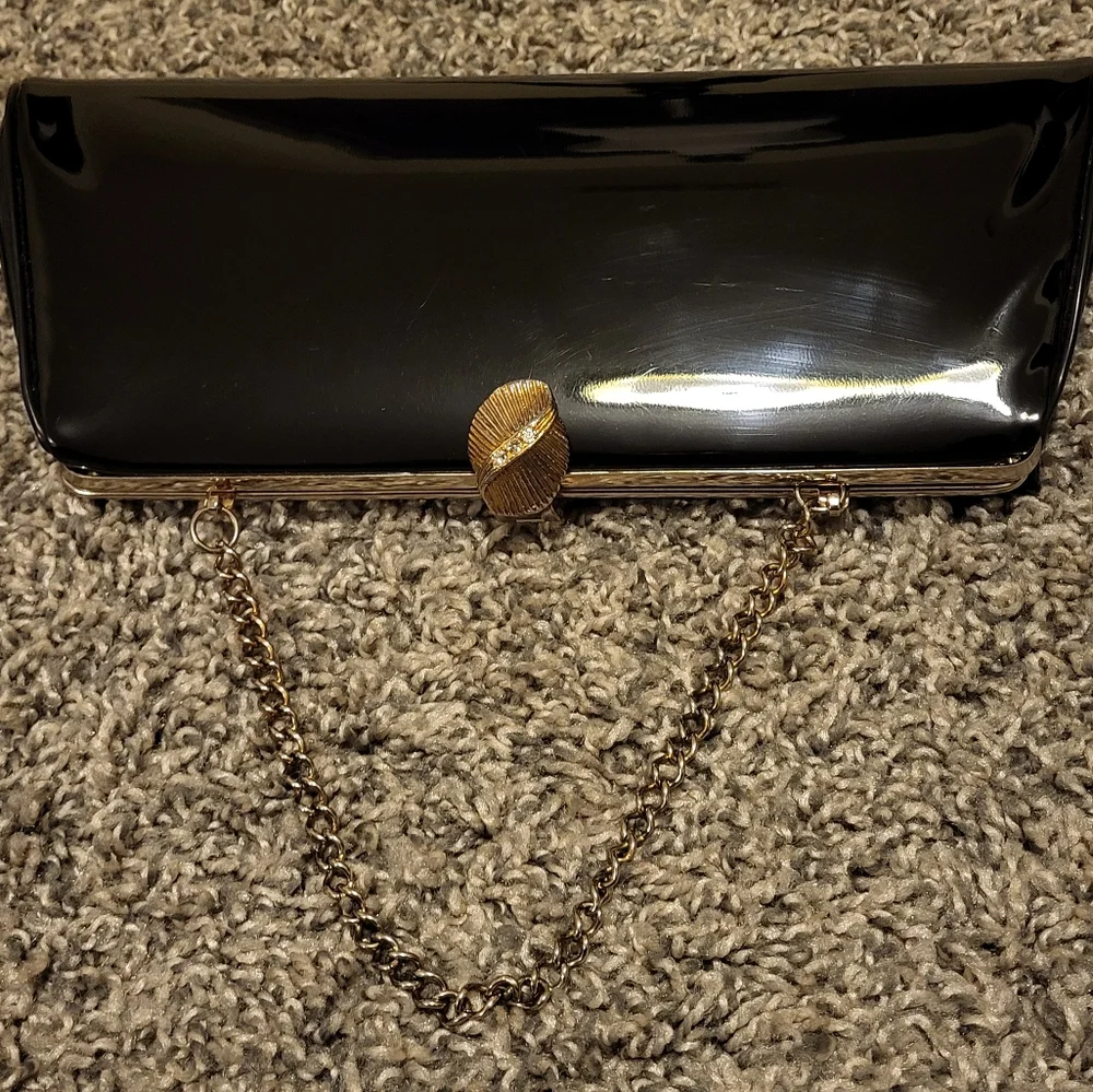 Elegant Black Clutch Bag with gold-tone hinged clasp and gold chain